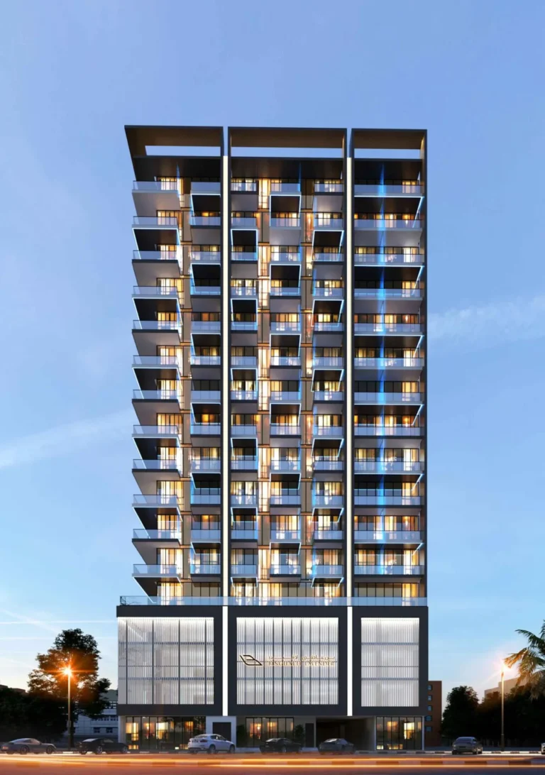 Modern residential high-rise building in the evening with colorful lighting and glass balconies.