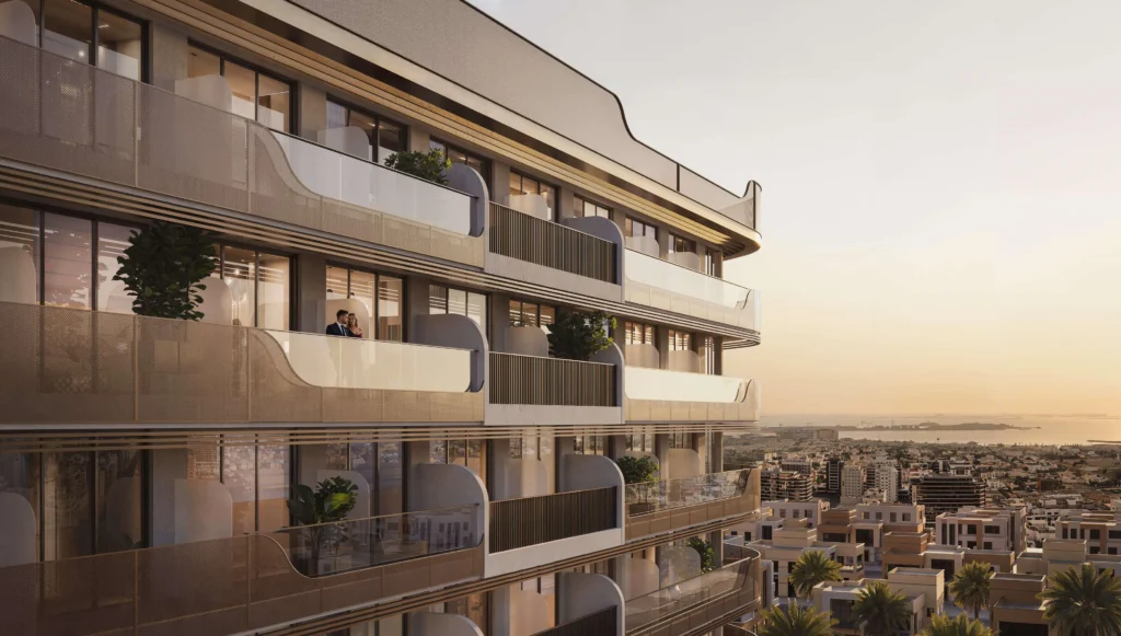 Modern building with balconies and sunset views of the city.