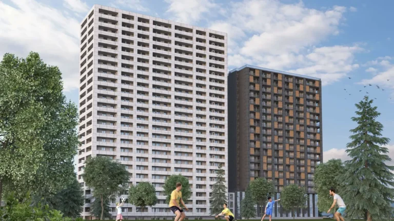 High-rise apartment buildings and people playing soccer against the summer sky.