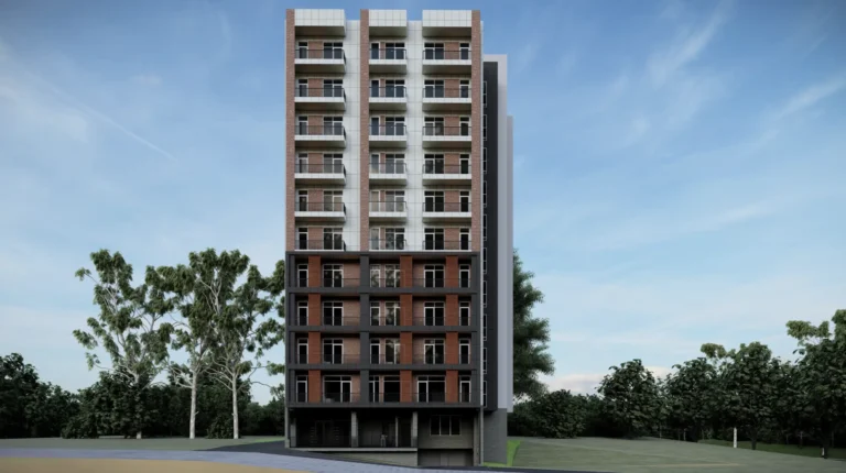 A residential apartment building with trees against a clear sky.