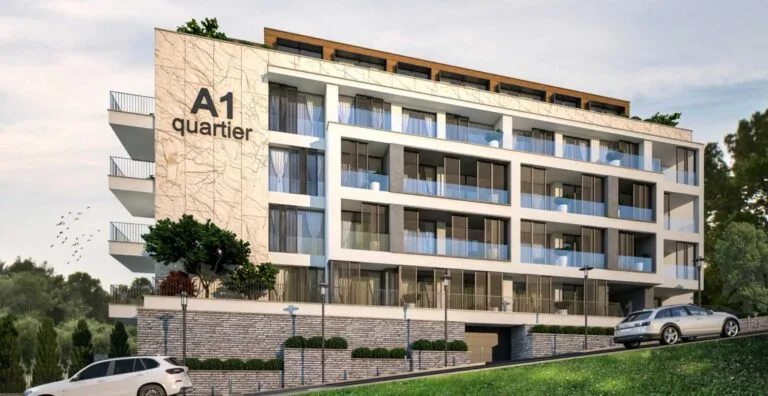 A modern building with balconies and cars against a green landscape, labeled A1 quartier.