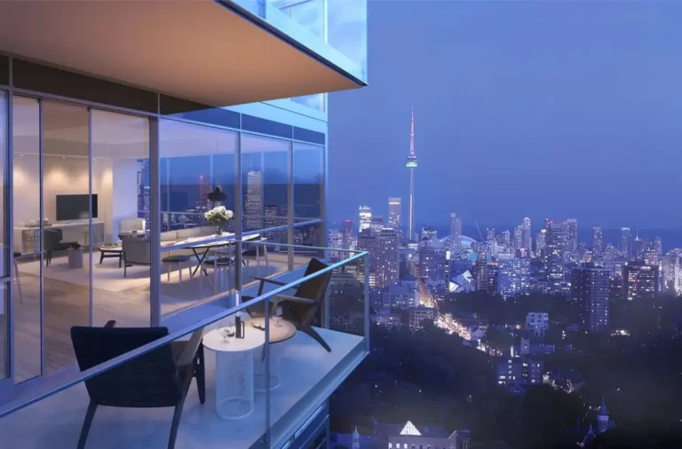 Modern apartment with balcony and views of the night city and the tower in the distance.