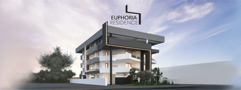 Современное здание Euphoria Residence на фоне ясного голубого неба и зелени.