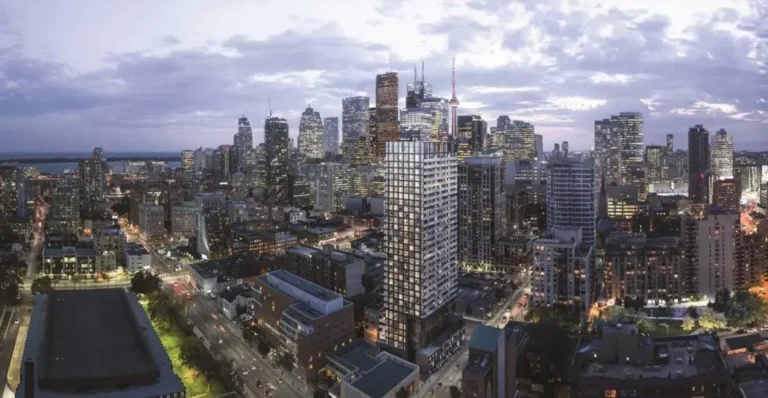 Toronto's skyscrapers against the backdrop of sunset, city lights and the CN tower dominate the landscape.