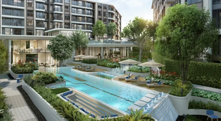 A modern residential complex with a swimming pool and green spaces on the background of a multi-storey building.