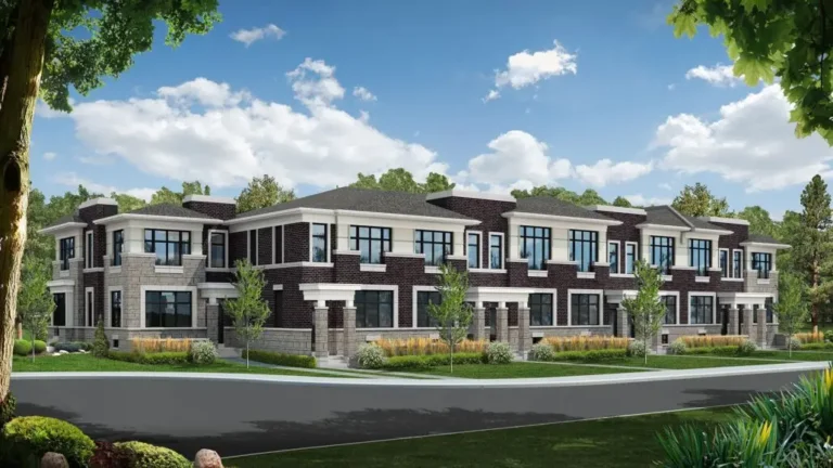 Modern townhouses with large windows and trees against a backdrop of blue sky and clouds.