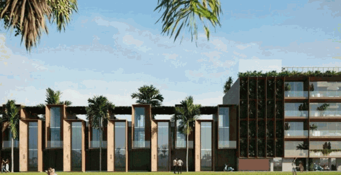 Un edificio moderno con vegetación contra un cielo azul y dos personas sobre un césped verde.