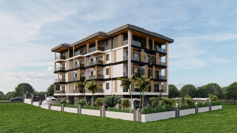 Modern apartment building with garden and parking lot against a clear sky.