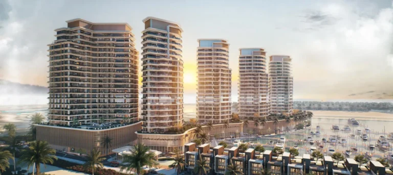 Modern high-rise buildings against the backdrop of sunset and palm trees by the water's edge.