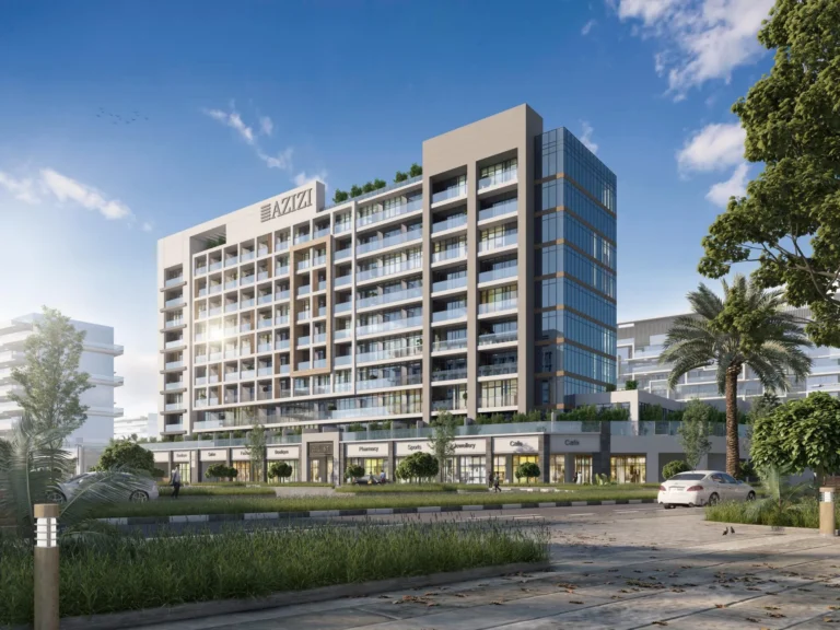 A modern residential building with balconies and stores, surrounded by greenery under blue skies.