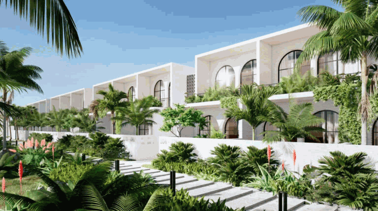 Modernas casas blancas con grandes ventanales y vegetación contra un cielo azul.