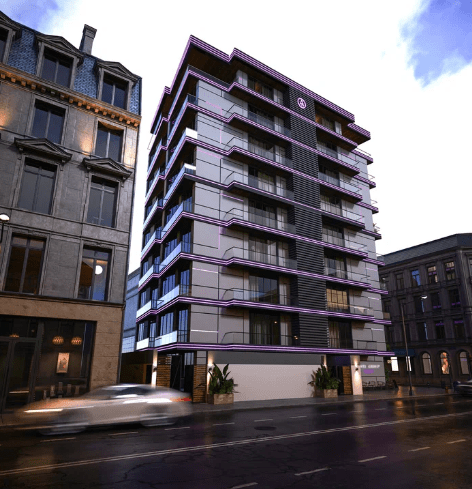 Un bâtiment moderne avec des balcons à plusieurs étages dans une rue de la ville, à la lumière du jour.