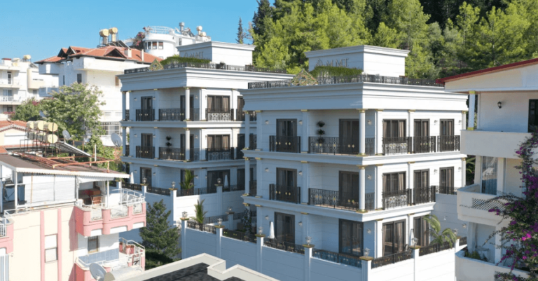 Modern apartment buildings with balconies and trees in the background, sunny day.